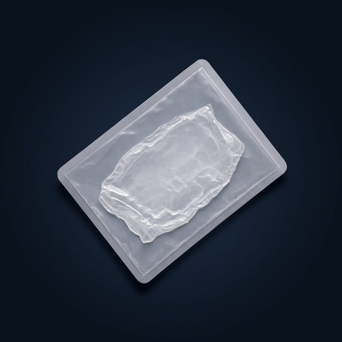 A thin translucent membrane sealed in a clear medical pouch